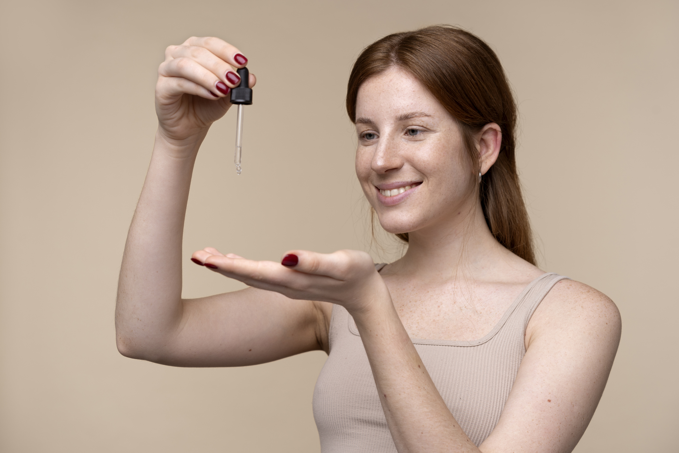 portrait-young-woman-pouring-serum-her-hand.jpg