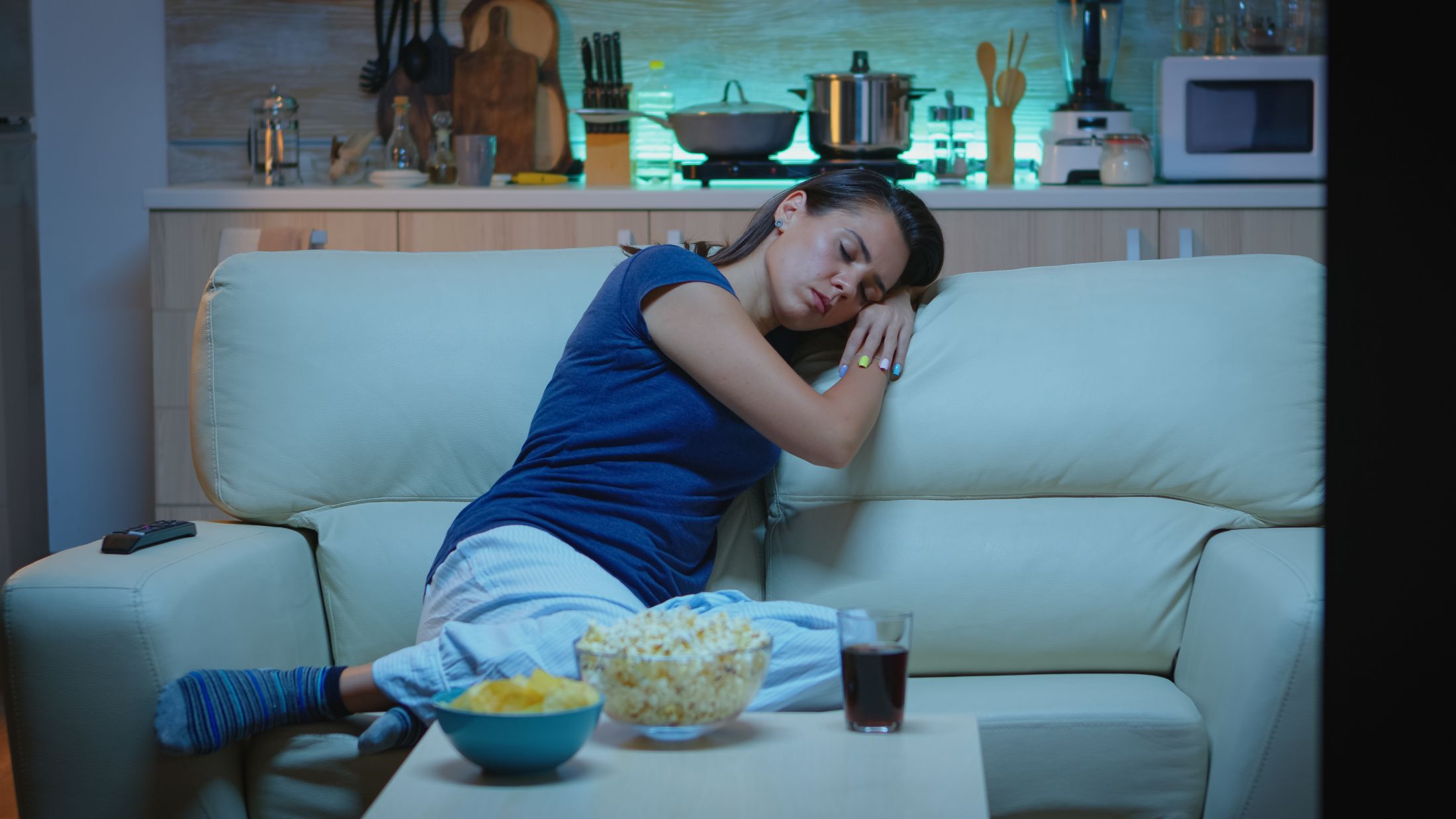 woman-sleeping-on-a-sofa-in-front-of-tv-while-watching-a-bored-movie-tired-exhausted-lonely-sleepy-lady-in-pajamas-falling-asleep-sitting-on-cozy-couch-in-living-room-closing-eyes-at-night.jpg
