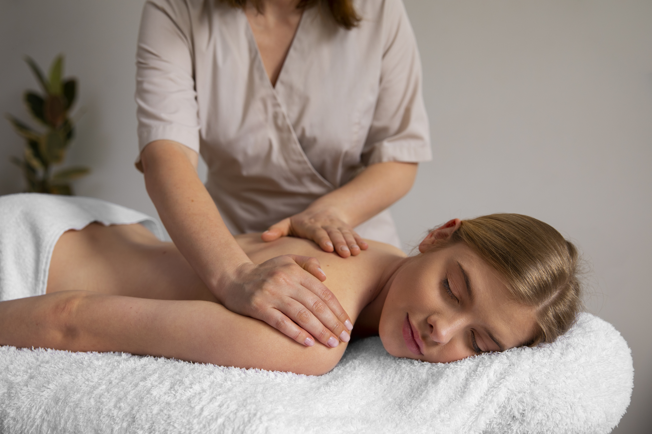 woman-getting-a-back-massage-from-masseur.jpg